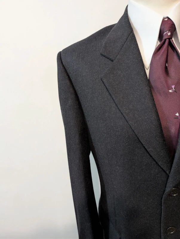 Heavy, evil, gray flannel suit