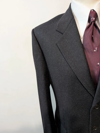 Heavy, evil, gray flannel suit