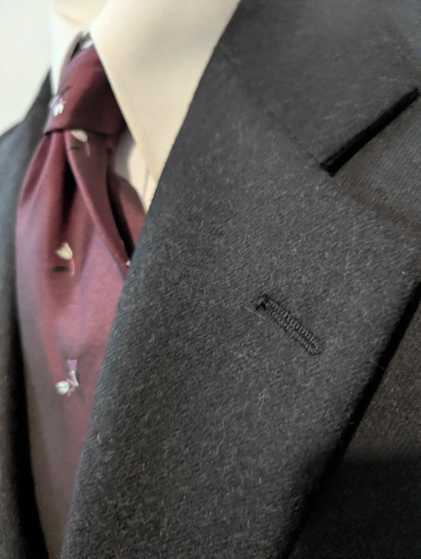Heavy, evil, gray flannel suit